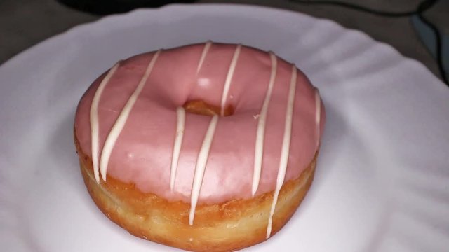 Pink Donut Doughnut footage video on slow motion rotating rolling plate