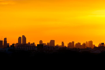 Fototapeta na wymiar yellow and dark sunset at city building
