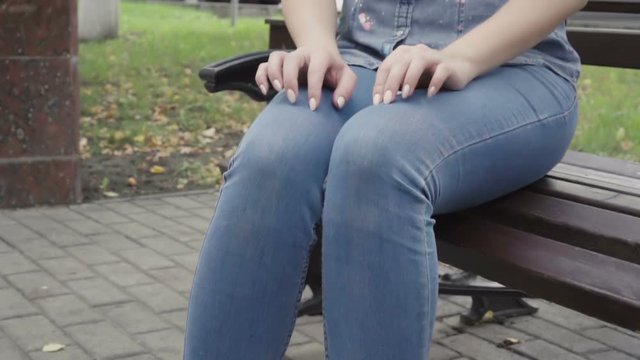 Unrecognizable woman waiting someone on bench in park