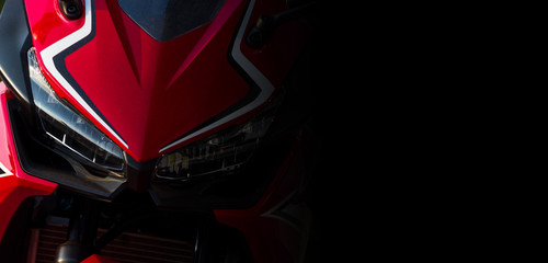 closeup headlight front view of motorcycle bigbike in showroom with soft-focus and over light in the background © memorystockphoto