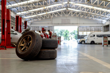 closeup old tire in car repair station with soft-focus and over light in the background