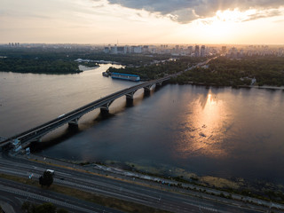 Aerial view to Metro Bridge through the Dnipro river with view to cityscape of Kiev, Ukraine
