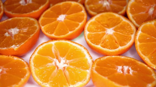 Orange slices oranges footage video on slow motion rotating rolling plate