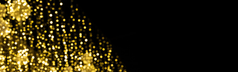 Fototapeta na wymiar Magic shiny bokeh lights background, fantastic abstract pattern. Beautiful golden glowing Christmas decoration on black