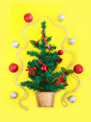 green Christmas tree with decor and shiny colorful toys balls for the New Year holiday