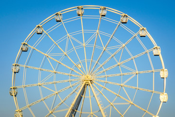 Ferris wheel against the blue sky