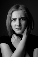 Worried young woman. Studio portrait. Black and white