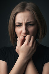 Worried young woman. Studio portrait