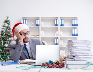 Young businessman celebrating christmas in the office