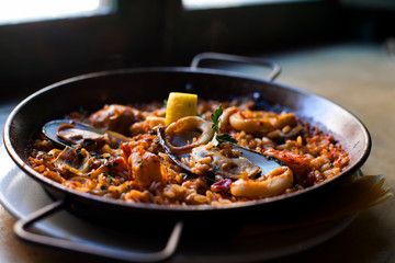 Traditional Spanish dish Paella with seafood in a large frying pan. Selective focus, shallow depth of field