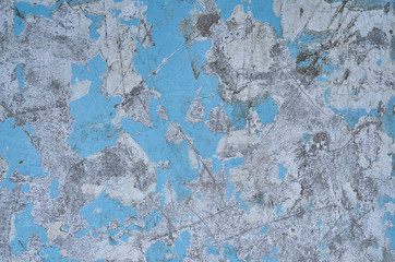texture of the old battered wall blue peeling paint, concrete, gray cement grunge