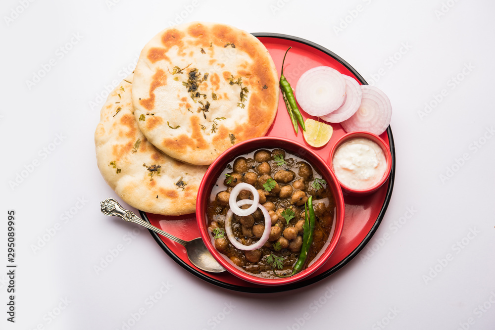 Canvas Prints Pindi Chole Kulche or roadside choley Kulcha popular in India and pakistan is a popular streetfood. It's a spicy Chickpea or chana curry served with Indian Flat Bread. selective focus