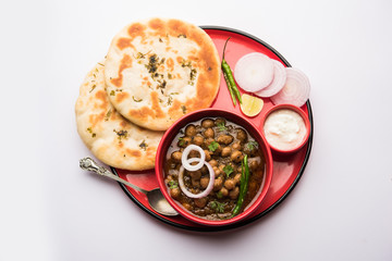 Pindi Chole Kulche or roadside choley Kulcha popular in India and pakistan is a popular streetfood. It's a spicy Chickpea or chana curry served with Indian Flat Bread. selective focus
