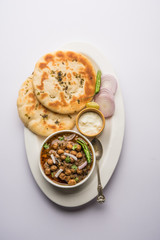 Pindi Chole Kulche or roadside choley Kulcha popular in India and pakistan is a popular streetfood. It's a spicy Chickpea or chana curry served with Indian Flat Bread. selective focus