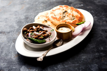 Pindi Chole Kulche or roadside choley Kulcha popular in India and pakistan is a popular streetfood. It's a spicy Chickpea or chana curry served with Indian Flat Bread. selective focus