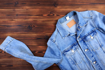 blue denim jean jacket  on wooden background.