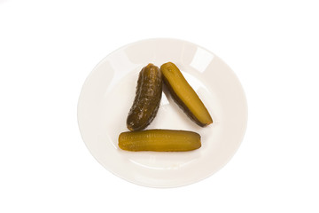 Pickles on a plate on a white background