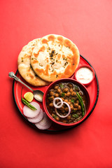 Pindi Chole Kulche or roadside choley Kulcha popular in India and pakistan is a popular streetfood. It's a spicy Chickpea or chana curry served with Indian Flat Bread. selective focus