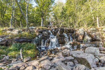 Fototapeta na wymiar Ramhultavägen waterfall with moving water due to slow shutter speed lies in the river Ramnån and flows out into Lake Lygnern in the Västra Götaland region near the town of Sätila in Sweden