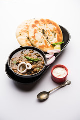 Pindi Chole Kulche or roadside choley Kulcha popular in India and pakistan is a popular streetfood. It's a spicy Chickpea or chana curry served with Indian Flat Bread. selective focus