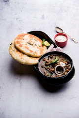 Pindi Chole Kulche or roadside choley Kulcha popular in India and pakistan is a popular streetfood. It's a spicy Chickpea or chana curry served with Indian Flat Bread. selective focus