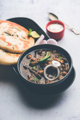 Pindi Chole Kulche or roadside choley Kulcha popular in India and pakistan is a popular streetfood. It's a spicy Chickpea or chana curry served with Indian Flat Bread. selective focus