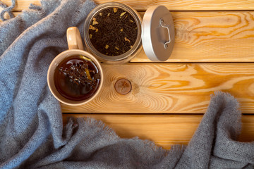 cup of tea, grey scarf on a wooden background. autumn mood.flat lay