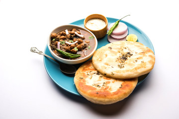 Pindi Chole Kulche or roadside choley Kulcha popular in India and pakistan is a popular streetfood. It's a spicy Chickpea or chana curry served with Indian Flat Bread. selective focus