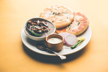 Pindi Chole Kulche or roadside choley Kulcha popular in India and pakistan is a popular streetfood. It's a spicy Chickpea or chana curry served with Indian Flat Bread. selective focus