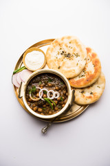 Pindi Chole Kulche or roadside choley Kulcha popular in India and pakistan is a popular streetfood. It's a spicy Chickpea or chana curry served with Indian Flat Bread. selective focus
