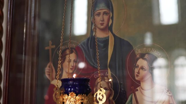 VLADIVOSTOK, RUSSIA - FEBRUARY 20, 2018: Icon of holy Faith, Hope and Charity in russian church and small candle burning in front of it