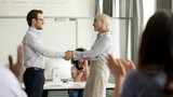 Mature director holding hands of best employee express praising gratitude