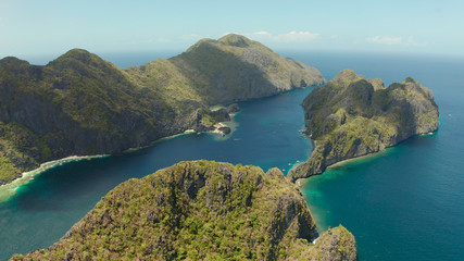 Fototapeta na wymiar Seascape with tropical rocky islands, ocean blue water, aerial view . islands and mountains covered with tropical forest. El nido, Philippines, Palawan. Tropical Mountain Range