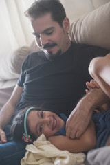 Father and daughter at home playing in sofa