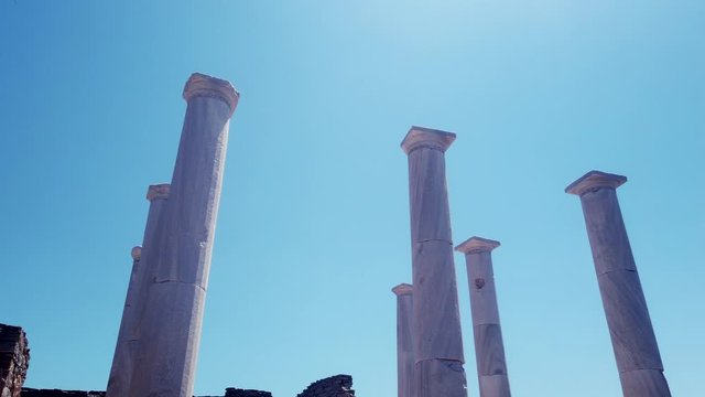 Low angle pan right shot of Delos Archaeological Site, Mykonos, Greece