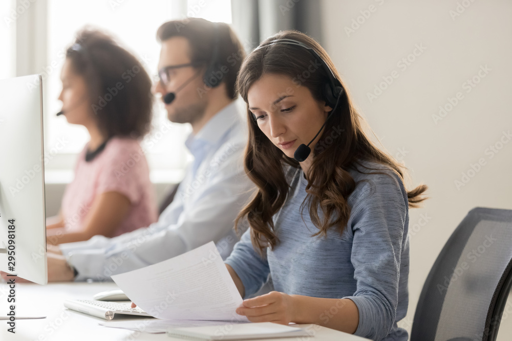 Sticker customer support phone operator sitting at workplace holds read document