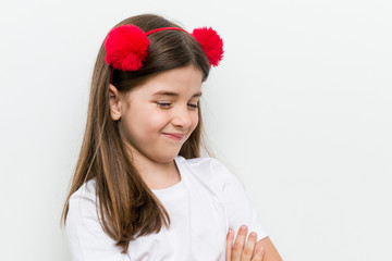 Little caucasian girl with costume and accessories having fun