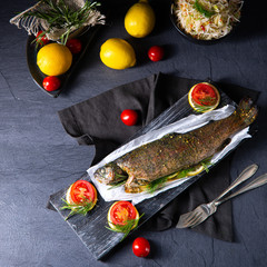 baked trout with herb filling and tomatoes