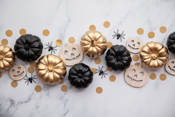 Fototapeta na wymiar Halloween luxury gold and black pumpkin flat lay background composition