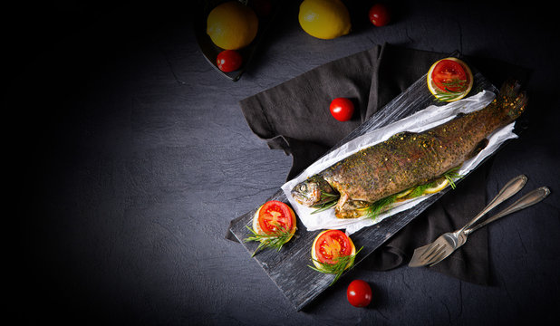 baked trout with herb filling and tomatoes