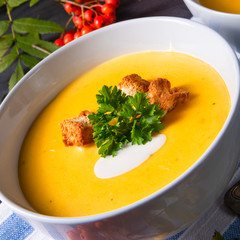 Delicious pumpkin soup with croutons and coconut milk