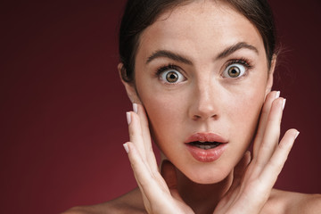 Image of surprised shirtless woman looking at camera in wonder