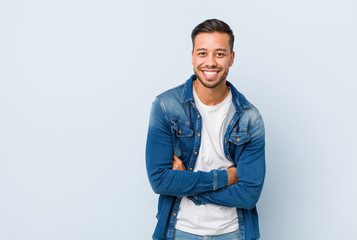 Young handsome filipino man laughing and having fun.
