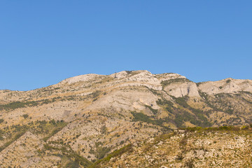 Fototapeta na wymiar Mountains against the blue sky . Mountains in Montenegro. Selective focus.