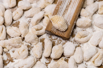 Cook homemade gnocchi on the table, Italian tradition