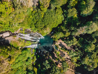 Aerial view of waterfall with transparent water in jungle