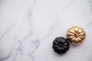 Luxury gold and black autumn pumpkin flat lay composition on a marble background