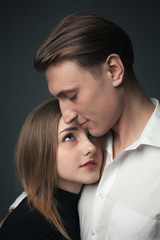 Young passionate couple in love hugging in studio. Close up
