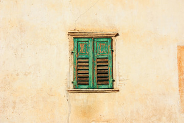 Fototapeta na wymiar Old window with green shutters