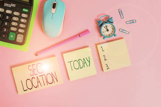 Conceptual hand writing showing Seo Location. Concept meaning process to optimize pages on your site to show for organic Notepads alarm clock calculator sheet marker colored background - Powered by Adobe